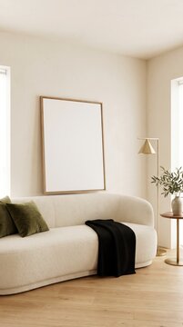 Blank wood framed poster mockup above curved sofa with olive pillows and black throw