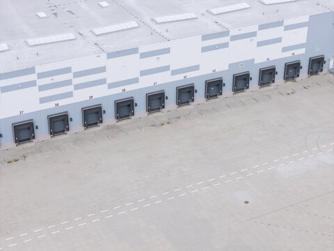 Aerial view of a modern warehouse loading dock area with numbered bays in Tczew, Poland.