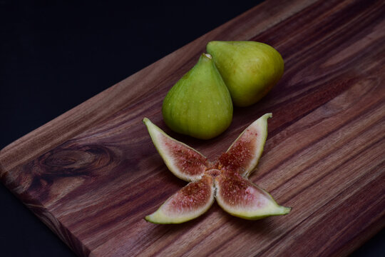 Fresh figs and a sliced fig on a charcuterie board