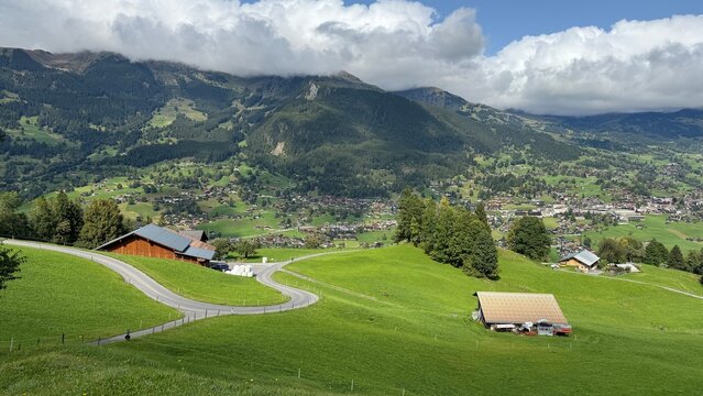 Grindelwald village and green alpine meadows beneath the Swiss Alps