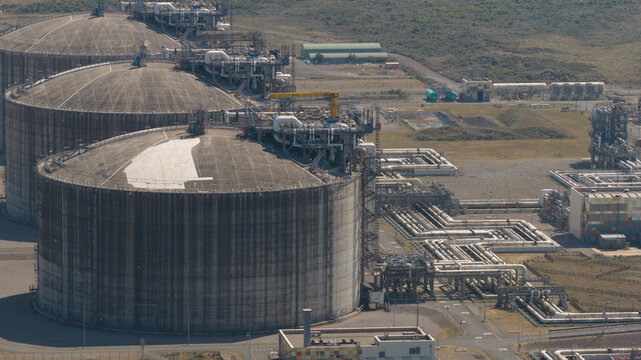 Aerial view of Dunkirk LNG Terminal with large storage tanks and industrial infrastructure in Loon-Plage, Hauts-de-France, France.