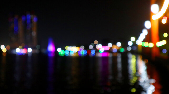 Colorful Waterfront Bokeh and Ferris Wheel Lights at Night