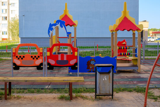 Colorful outdoor playground for children located in modern urban apartment block yard. Urban development and safe play areas for kids.
