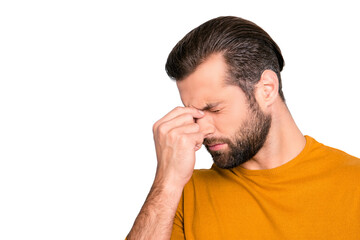 Fototapeta premium Close up portrait of stressed sick sad upset bearded guy with stylish haircut touching nose-bridge isolated on gray background copy-space