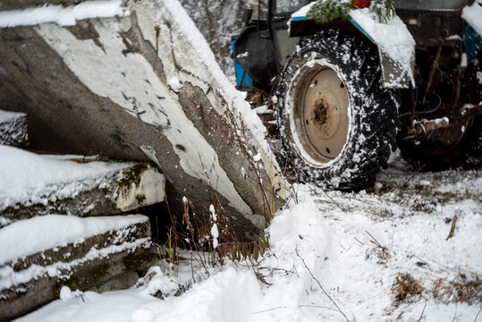 tractor stuck  behind concrete debris