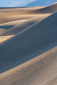 Beautiful vertical abstract sand dunes texture with layers of shadows