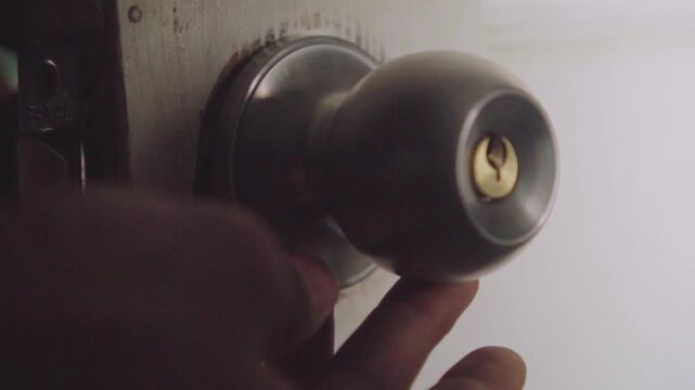 Handyman installing new door knob lock
