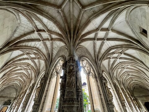 Low angle view of Gothic ribbed vault ceiling and sculpted column in San Juan de los Reyes cloister, Toledo