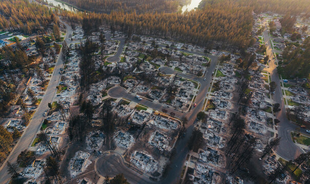 Aerial view of the aftermath of the Spokane wildfire showing destroyed homes, charred trees, and debris scattered across a suburban neighborhood in Spokane, Washington, United States.