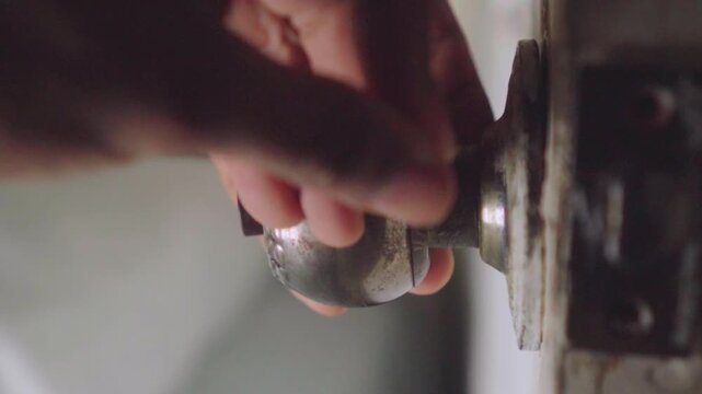 Handyman replacing old antique doorknob lock