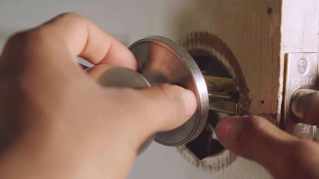 Close up of handyman installing a new door knob