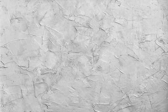 Abstract concrete background - in the form of a rough covered with folds wall, closeup