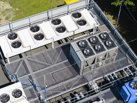 Aerial view of industrial cooling units and ventilation fans on the rooftop of an AI data center in Poland.