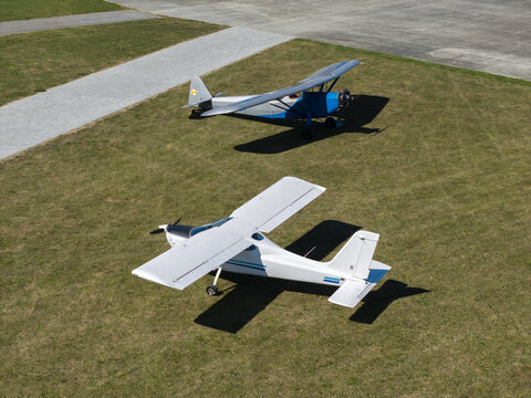 Aerial view of two light aircraft parked on a grassy airfield in Poland.