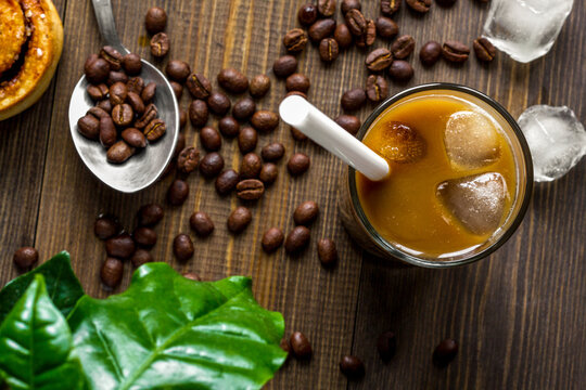 coffee with ice in glass on wooden background top view