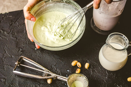 organic ice cream homemade process on dark background with hands