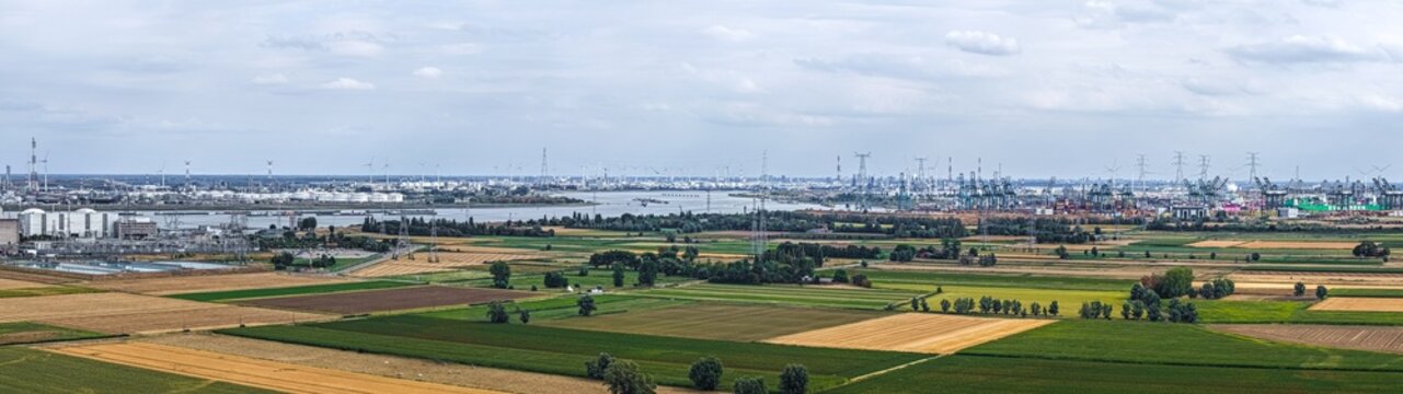 Aerial view of the Doel Nuclear Power Plant with agricultural fields and industrial infrastructure along the Scheldt river in Beveren-Kruibeke-Zwijndrecht, Vlaanderen, Belgium.