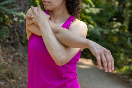 Woman Stretching Arm Before Run Outdoors At Little Mountain Stairs Chilliwack BC Canada