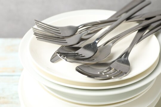 Ceramic dishware and cutlery on table, closeup