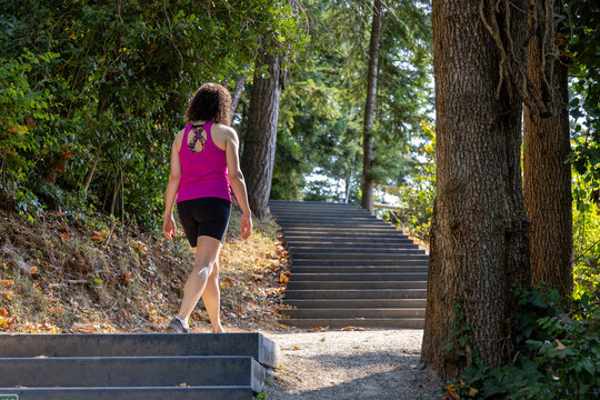 Woman Walking Up Outdoor Stairs Through Forest Park for Fitness at Little Mountain Stairs, Chilliwack, BC