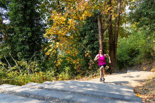 Woman Running Up Outdoor Stairs During Autumn Workout at Little Mountain Stairs, Chilliwack, BC Canada