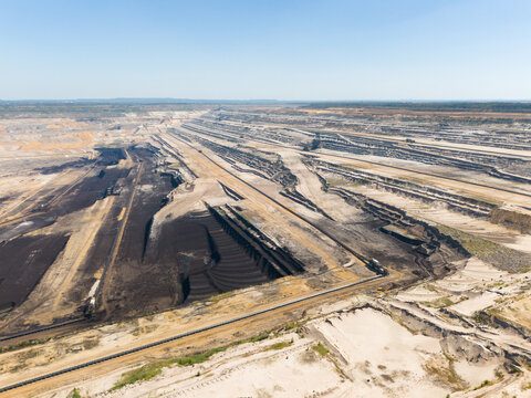 Aerial view of the Hambach open pit mine showing extensive lignite mining operations, deep excavation terraces, and industrial infrastructure in Elsdorf, North Rhine-Westphalia, Germany.