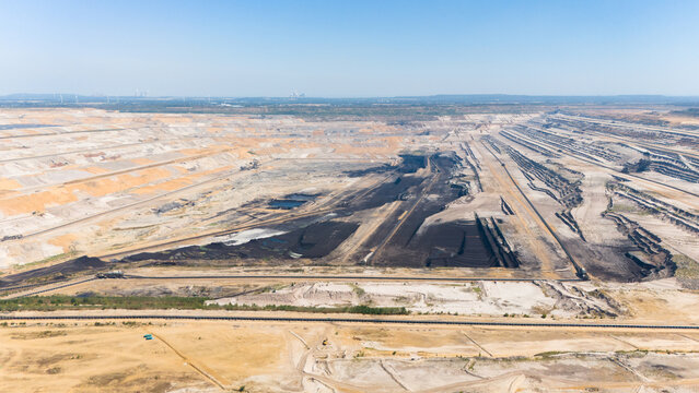 Aerial view of the Hambach open pit mine showing extensive lignite mining operations with deep terraced excavations and industrial infrastructure in Elsdorf, North Rhine-Westphalia, Germany.