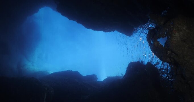 blue light reflection in cave moving lights underwater ocean scenery of cave withice lightning scuba divers to explore