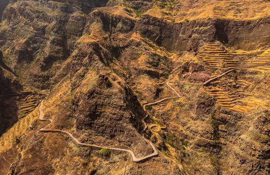 Aerial view of the winding road leading to Fontainhas village in the rugged landscape of Santo Antao, with dramatic terraced cliffs in Ponta do Sol, Ribeira Grande, Cabo Verde.