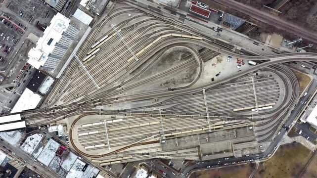 Top Down Aerial View of Large Urban Railway Yard and Train Tracks