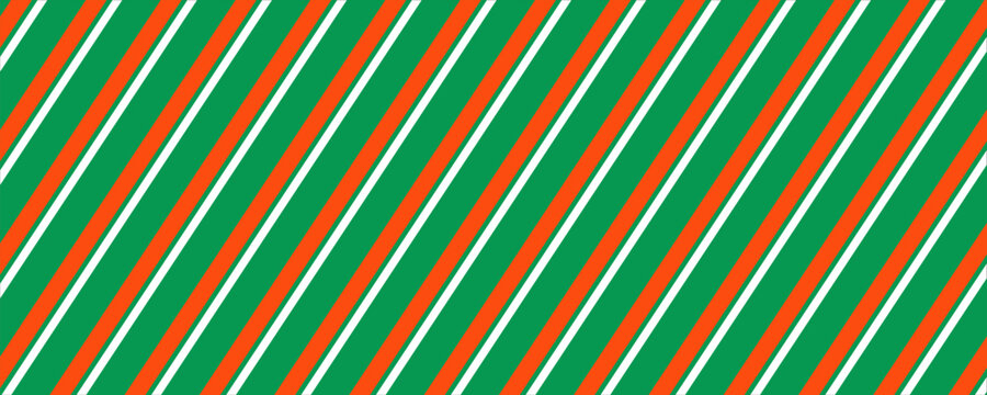 Striped candy cane Christmas seamless pattern. Red and green diagonal lines wallpaper. Winter holiday present wrapping paper. Vector gift decor backdrop. Xmas peppermint repeating background.  