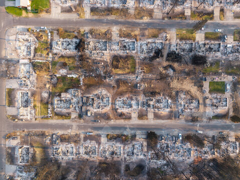 Aerial view of wildfire damage in a residential neighborhood with destroyed homes, charred foundations, and debris in Spokane, Washington, United States.