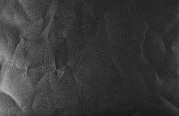 Distressed, creased and scratched black paper background, texture. Design element © dule964