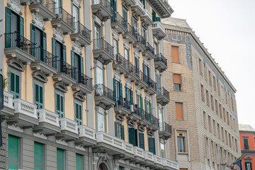 Fototapeta premium Elegant Historic Building Facade with Balconies and Green Shutters