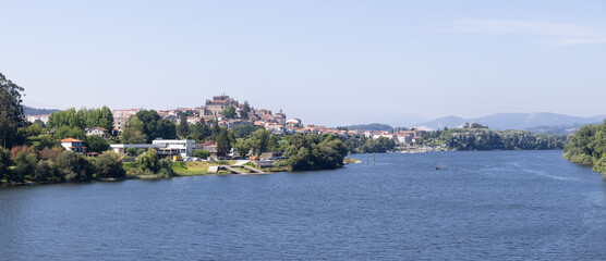 Fototapeta premium panoramic view of tui town and cathedral over minho river in galicia spain
