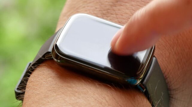 Businessman tapping smart watch display outdoor blurred background wrist using tapping touching man hands closeup macro digital touchscreen display futuristic tech trendy wearable smartwatch