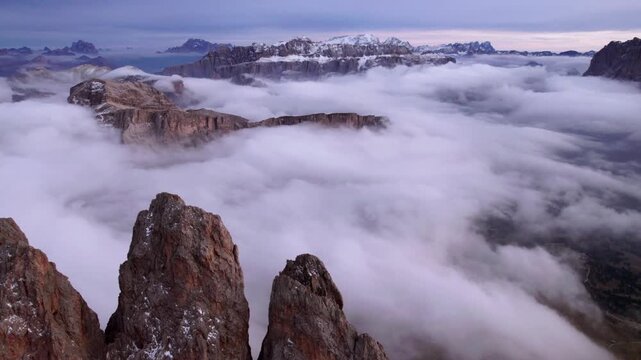 Panoramic aerial view of Sella and Sassolungo mountains with cloud inversion in the valley