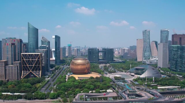 A panoramic daytime view of a modern urban district featuring distinctive architectural structures and lush green spaces.