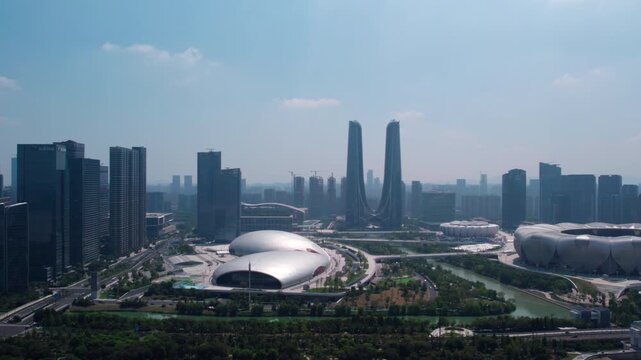 A daytime panoramic view of a modern urban district featuring distinctive architectural structures including domes, towers and high-rise buildings.