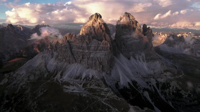 Panoramic aerial view of famous Tre Cime di Lavaredo mountain peak at sunset
