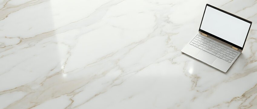Laptop with blank screen on marble surface, workspace setup