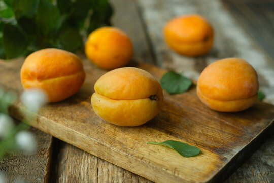 Fresh apricots on a wooden cutting board