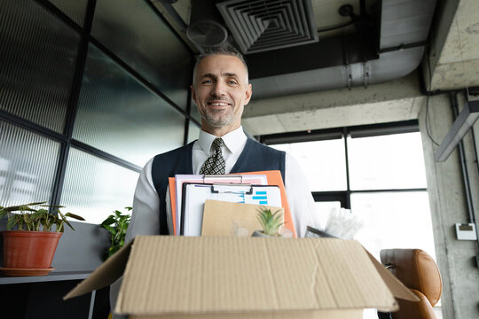 Taking box with personal stuff office. Guy got job. Hired manager in company. Hiring employee. Man office worker. Hired man hold box with his personal stuff. Fresh start.. Businessman got hired job