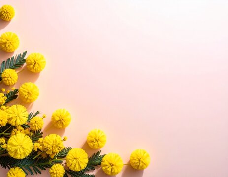 Mimosa flowers framing the corner of a soft pink background, spring flat lay with wide copy space