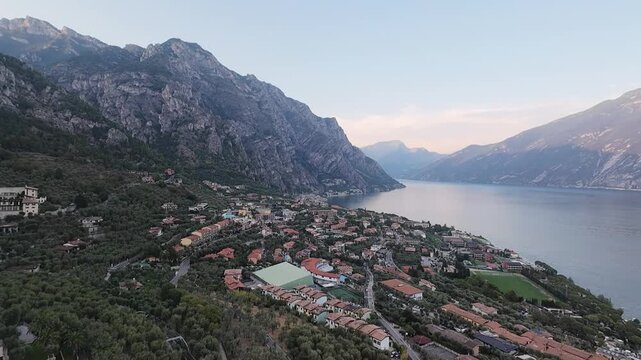 Stunning Aerial View of Limone sul Garda and Lake Garda Surrounded by Dramatic Mountains, Italy -4K