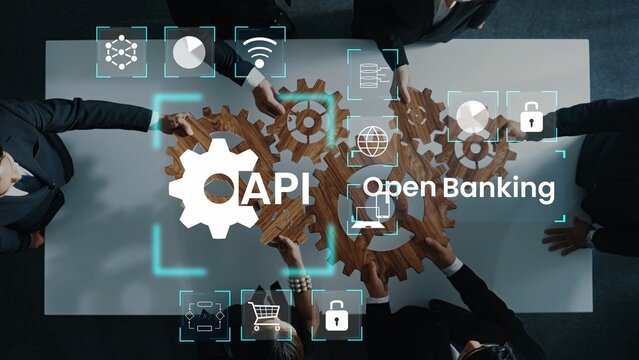 Group of business professionals collaborating on open banking strategy with API integration using gears and digital icons above a table in a modern office Gluon.