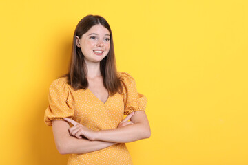 Obraz premium Beautiful girl with freckles on orange background, space for text