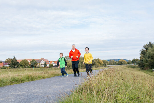 Father with sons enjoying outdoor jog together