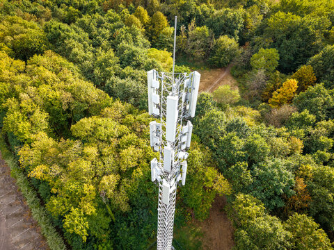 Aerial view of a cellular tower surrounded by a dense forest in The Netherlands.
