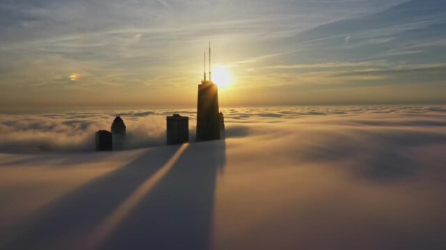 Aerial View of Chicago Skyscrapers Rising Above Fog at Sunset